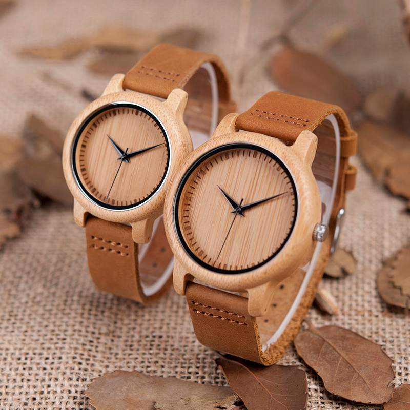 two beige bamboo watches with leaves